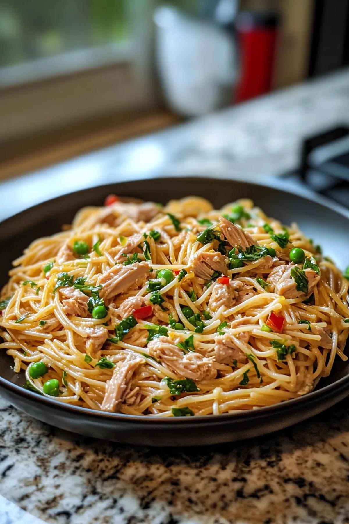 Brightly colored pasta with canned tuna, cherry tomatoes, and fresh herbs in a rustic bowl. card