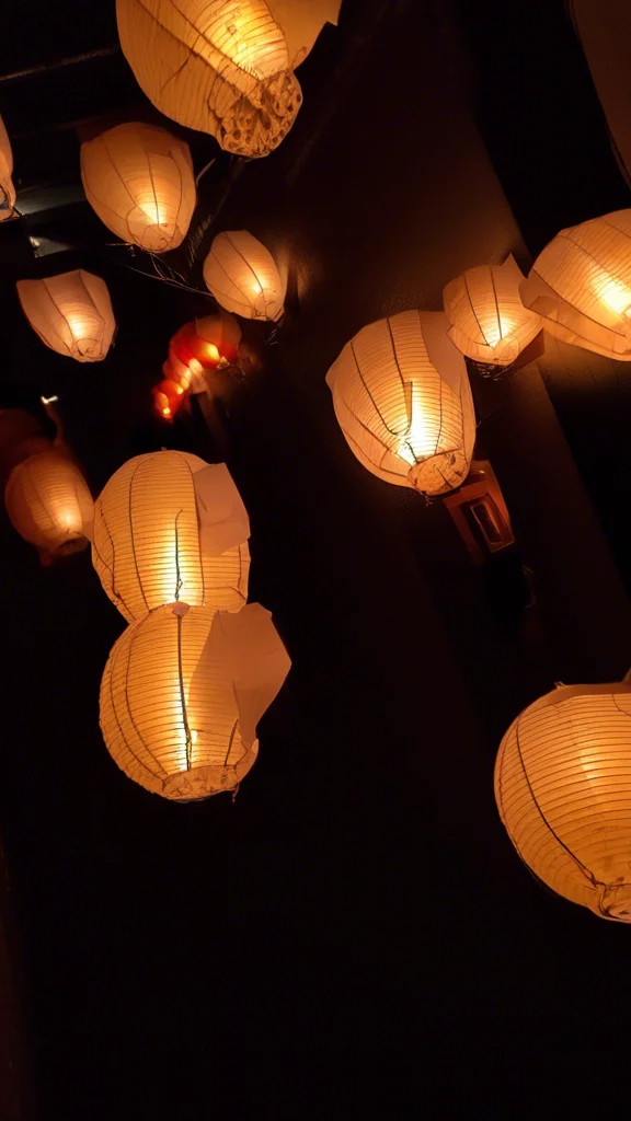 Warm Ambient Lighting with Paper Lanterns and Recessed Lighting - Cozy Cottage Design Idea